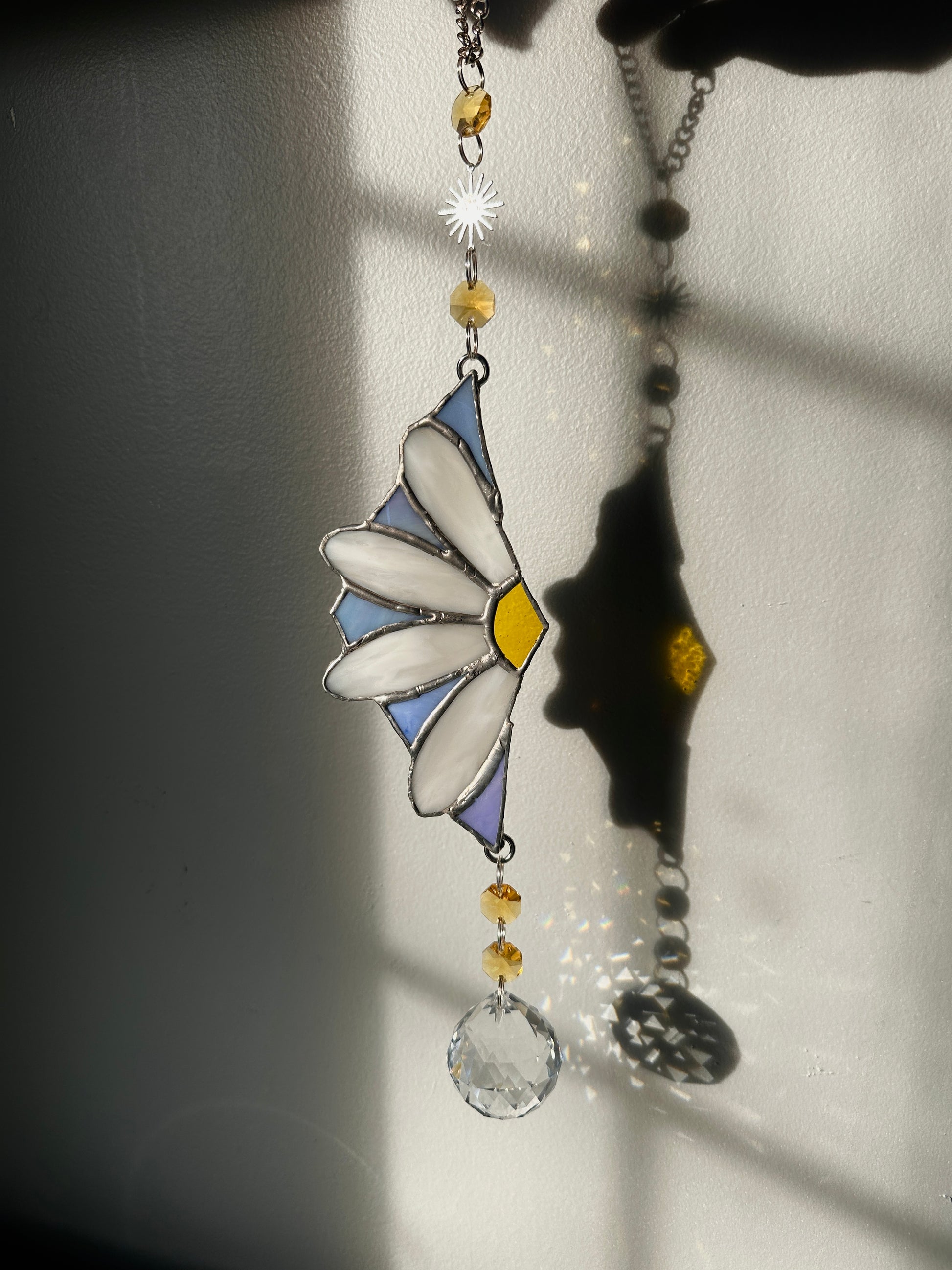 Decorative stained glass with a floral design on a plain background