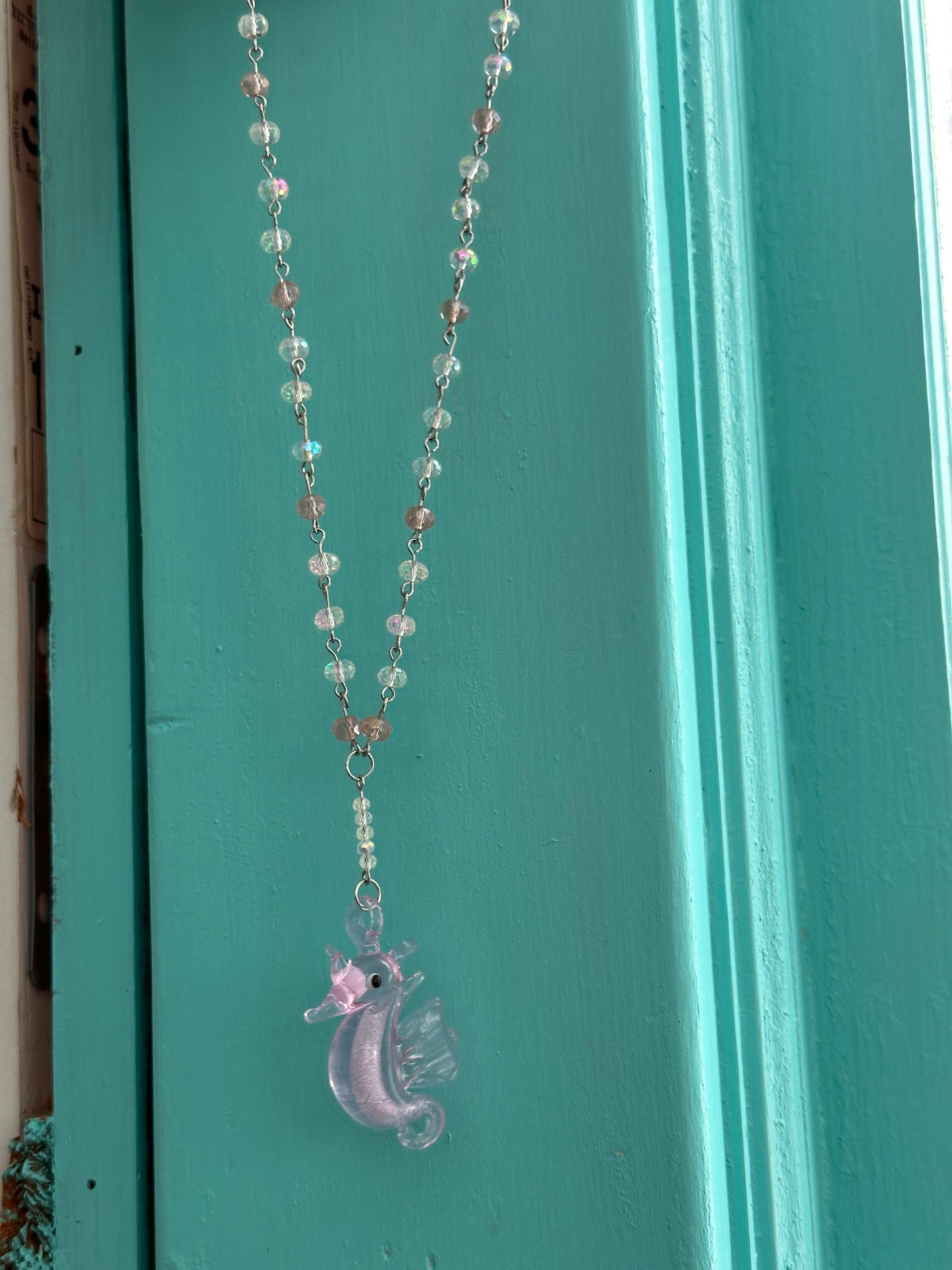 Pink and white iridescent glass seahorse necklace