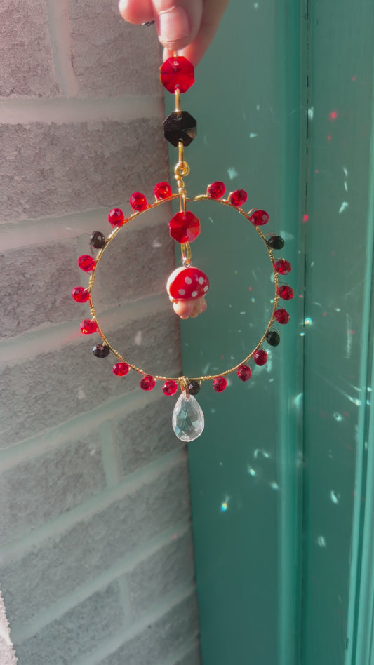 Red Mushroom Butt Suncatcher in a handmade frame